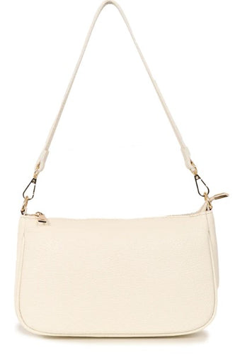 A classic leather baguette style handbag in cream. With gold hardware and a zip fastening to the top. Two detachable straps, one to be worn on the shoulder, and the longer length and adjustable strap to be worn long or across the body. Fabric lining with a zipped inner pocket and two inner pockets. 