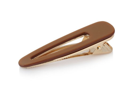 A chunky resin hair clip in bronze. Push opening and slide into your hair. Big Metal London. 