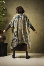 Load image into Gallery viewer, A lightweight, mid length kimono throwover in a design inspired by hand woven carpets, in soft beige/green with images in rust and navy