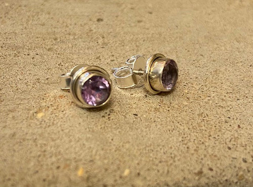 An amethyst, a semi precious stone, is encased within sterling silver to showcase this beautiful soft purple stone. With butterfly fastening to the back. 