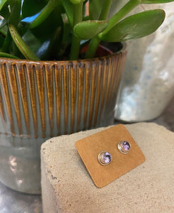 An amethyst, a semi precious stone, is encased within sterling silver to showcase this beautiful soft purple stone. With butterfly fastening to the back.