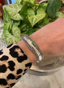 A sterling silver ladies cuff bracelet with milgrain detail to the edges - tiny dots make up this intricate detail. Adjustable. Sterling Silver 925.