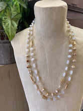 Load image into Gallery viewer, A short style ladies necklace featuring two strands for that layered look. White and gold beads in differing shades and shapes. Clasp adjustable fastening to the back.