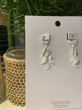 Load image into Gallery viewer, A simple silver hoop earring with strands of silver beads which hang from the base, with a mother of pearl charm to each,