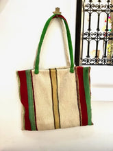 Load image into Gallery viewer, A truly unique tote bag. Handmade in Marrakech it features vertical stripes in neutral, red and yellow and green and a very subtle hint of brown. A large and spacious tote bag to wear over your shoulder. 