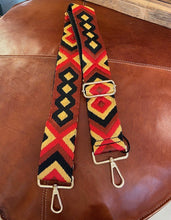 Load image into Gallery viewer, A detachable and adjustable bag strap. In a woven aztec design in shades of red, black and a gold toned yellow. With gold hardware. Style up your handbag with your own unique look. 
