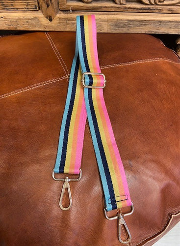 a detachable and adjustable bag strap in a multi stripe pastel rainbow design. With gold hardware you can clip it onto your favourite bag. 