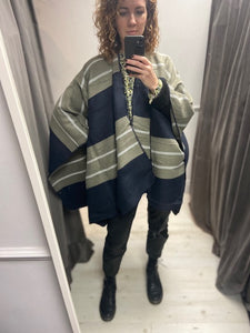This ladies cape is oversized and supersoft. With a shaped neckline, it simply drapes over your shoulders. With no fixed armholes it is so easy to wear. In a navy bold stripe and a navy blanket stitch to the edges. It is one size.