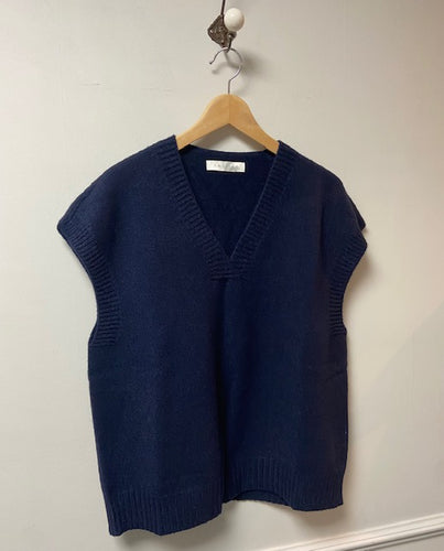 An easy to wear piece of knitwear which is supersoft. A sleeveless tank top, with a v neck. Ribbed hem, armholes and neckline to complete the look and keep its shape. A subtle crossover detail to the v neckline. A dark navy colourway. 