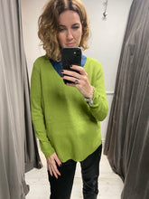 Load image into Gallery viewer, A fine knit piece of knitwear, long sleeves and a v neck. A loose fitting shape with a split hem to the sides. The hem is longer at the back for a flattering fit.