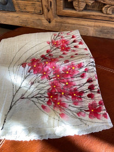 A hand painted pure silk ladies scarf. a pure silk cream coloured scarf with hand painted cherry blossoms to each end. Each scarf is truly unique with no two being the same. Hand painted by local ladies in Vietnam. the scarf has delicate tassels to each end.