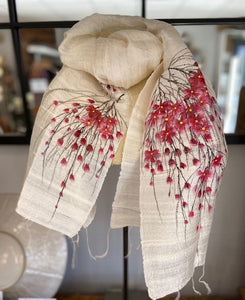 A hand painted pure silk ladies scarf. a pure silk cream coloured scarf with hand painted cherry blossoms to each end. Each scarf is truly unique with no two being the same. Hand painted by local ladies in Vietnam. the scarf has delicate tassels to each end.