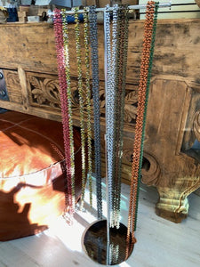 A long ladies necklace, handmade from bamboo beads attached to metal loops to create the long necklace. Wear it as it is, or wrap around to create a shorter necklace. Choose from a selection of colours. Made in Vietnam. 