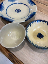 Load image into Gallery viewer, handmade in Vietnam, therefore no two bowls will be the same. With a beige coloured background, they are handpainted using a beautiful shade of blue. 15cm diameter.